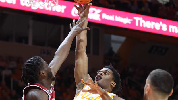 Arkansas Razorbacks Makhel Mitchell can't get high enough to block a shot by Tennessee's Tobe Awaka on Tuesday night.